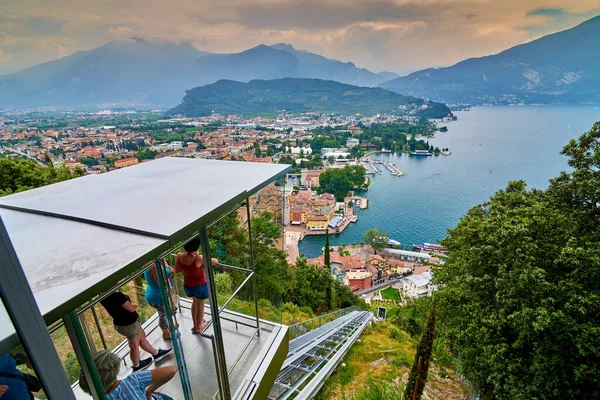 Riva del Garda, İtalya - 07 Temmuz 2020: Panoramic view of the beautiful Lake Garda and the Panoramic lift. Riva del Garda town and Garda lake in the umn time, Trentino Alto Adige region, Italy