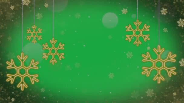 緑の背景にアニメーション黄金と白の雪の結晶 — ストック動画