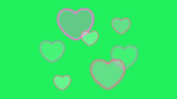 緑の背景に浮かぶアニメーションピンクのハート型 — ストック動画