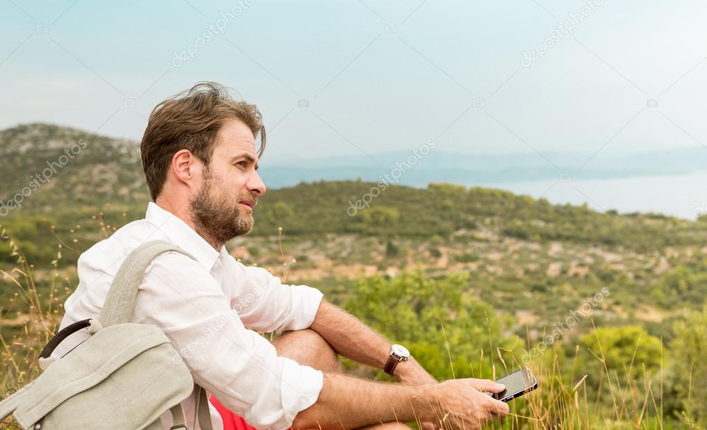 Tourist man taking a break while mountain trip