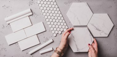 Interior design and home decoration - different shapes of white ceramic and gres tiles. Designer choosing bathroom or kitchen renovation materials. Captured from above (top view, flat lay). clipart