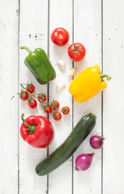 Mix of vegetables on white planked wooden background