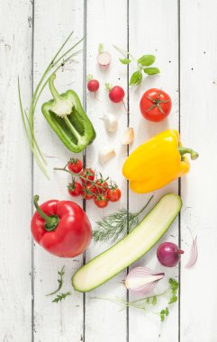 Mix of vegetables on white planked wooden background