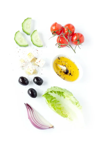 Greek salad recipe ingredients on white — стокове фото