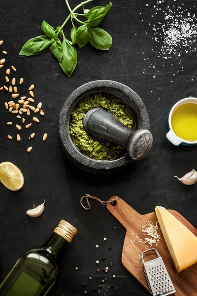 Green basil pesto - italian recipe ingredients on black chalkboad — Stok fotoğraf