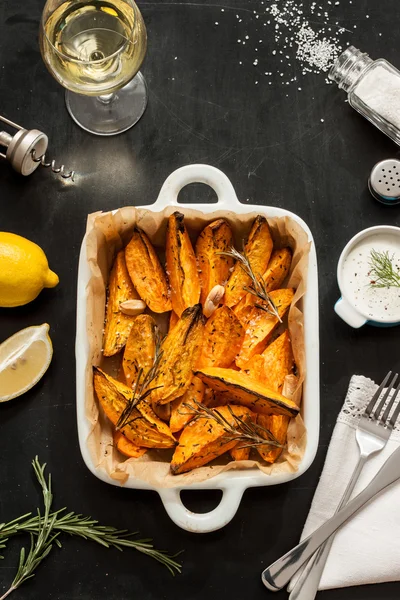 Roasted sweet potatoes in white ceramic dish