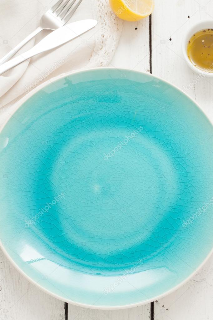 Table setting from above - blue ceramic empty plate