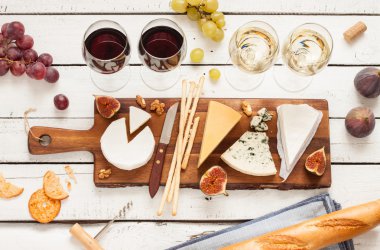 Red and white wine plus different kinds of cheeses