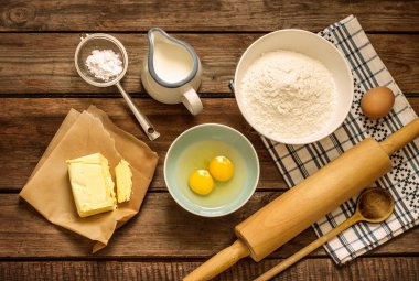 Baking cake in rural kitchen - dough recipe ingredients on wood