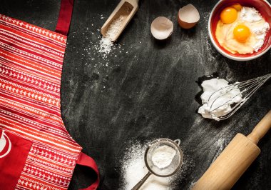 Baking cake ingredients on black chalkboard