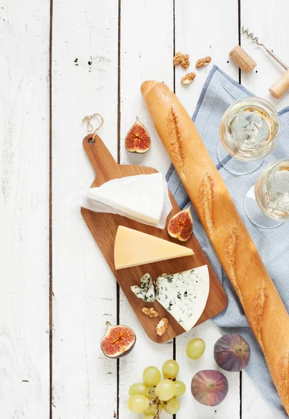 Different kinds of cheeses baguette and white wine