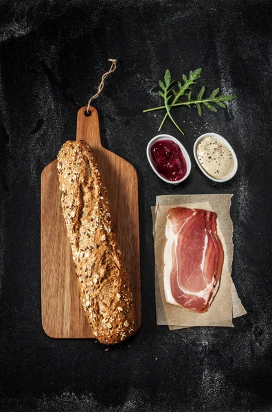 Prosciutto sandwich recipe - ingredients on black — Stock fotografie