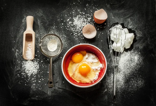 Baking cake ingredients on black chalkboard — Stock Photo, Image