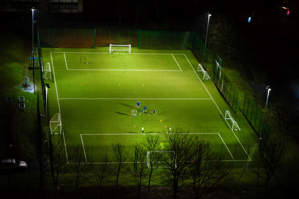 Playing football in housing scheme in Dennistoun of Glasgow at n