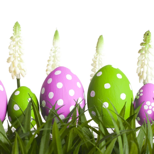 Row of Easter eggs on grass — Stock Photo, Image