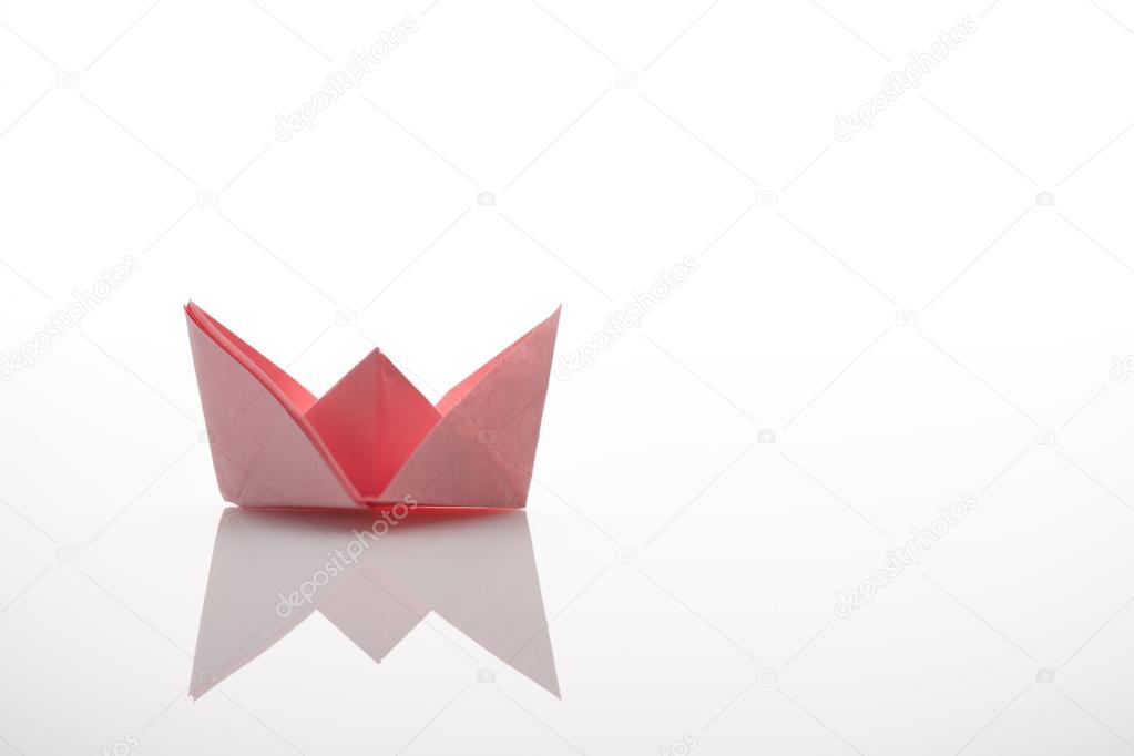 Leadership concept using blue paper ship