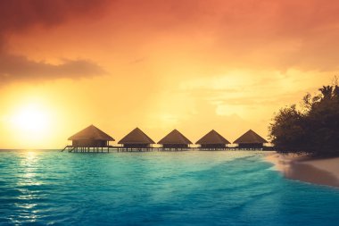 Sunset on Maldives island clipart