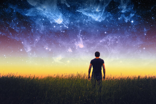 Silhouette of young man on stars sky. Elements of this image furnished by NASA.