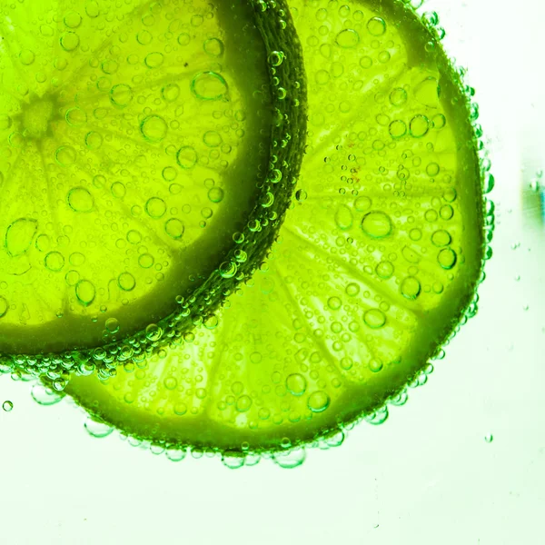 Slice of lime with water drops — Stock Photo, Image