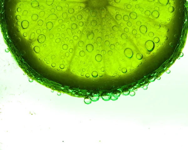 Slice of lime with water drops — Stock Photo, Image