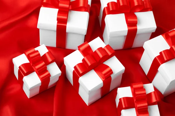 Gift on red satin background — Stock Photo, Image