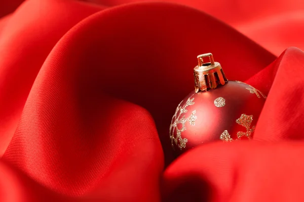 Red Christmas balls, wrapped in cloth — Stock Photo, Image