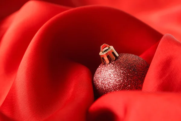 Red Christmas balls, wrapped in cloth — Stock Photo, Image