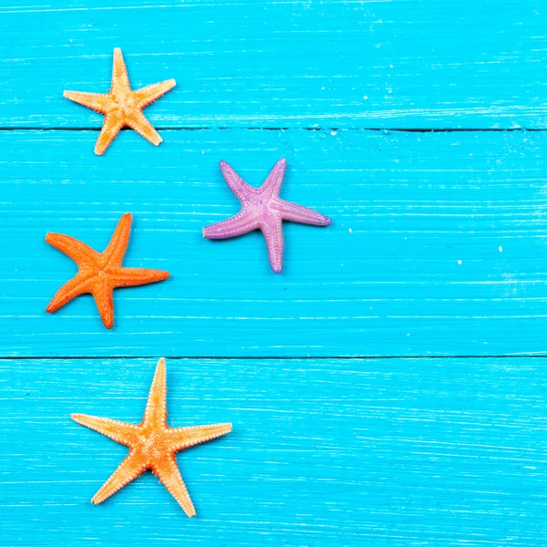 Starfish on painted rustic wooden boards — Stock Photo, Image