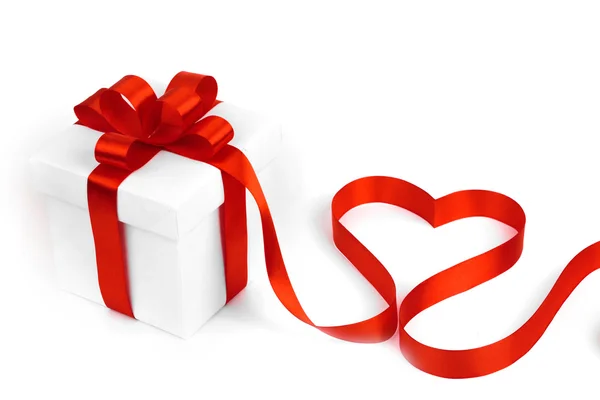 White boxes with red ribbons and decorative heart — Stock Photo, Image