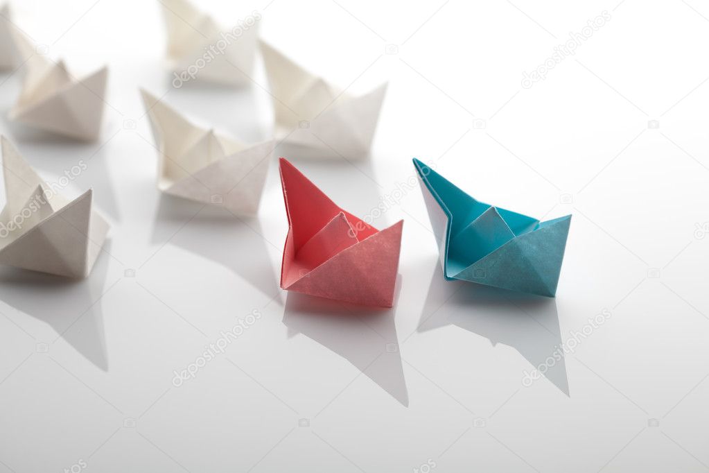 Leadership concept using blue paper ship