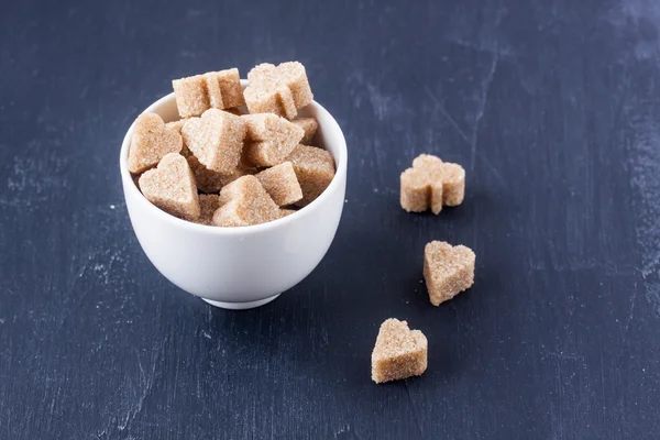 Brown heart and clubs shaped candy — Stock Photo, Image