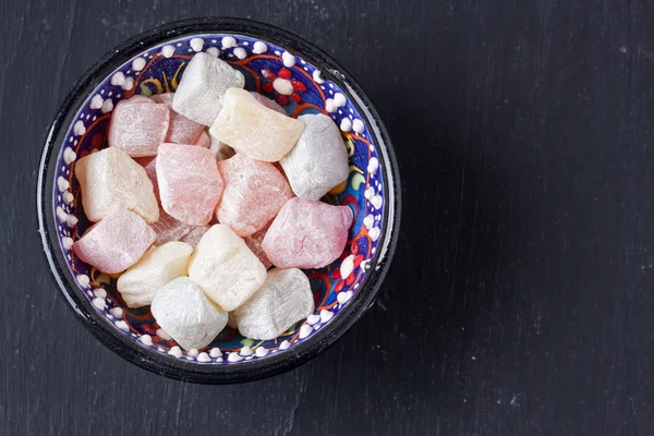 Turkish delight on a black background — Stock Photo, Image