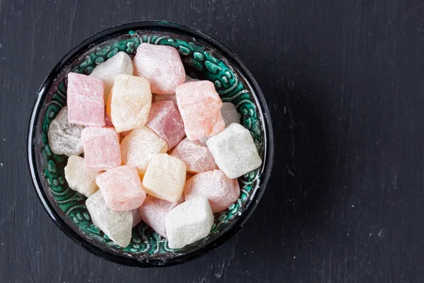 Turkish delight on a black background — Stock Photo, Image