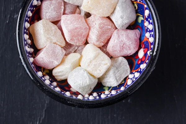 Turkish delight on a black background — Stock Photo, Image