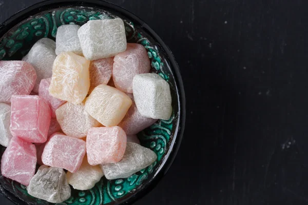 Turkish delight on a black background — Stock Photo, Image