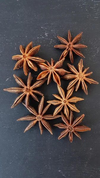 Star aniseed on a black wooden background — Stock Photo, Image