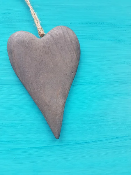 Wooden heart on a turquoise background — Stock Photo, Image