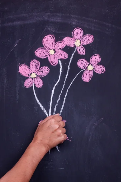 Hand holding chalk drawing flowers — Stock Photo, Image