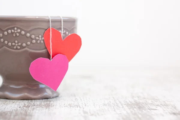 Cup with heart shaped tea bag — Stock Photo, Image