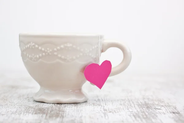 Cup with heart shaped tea bag — Stock Photo, Image