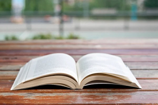 Reading at park, a book on a table — Stock Photo, Image