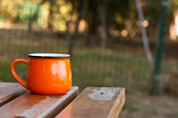 Orange enamel cup — Stock Photo, Image