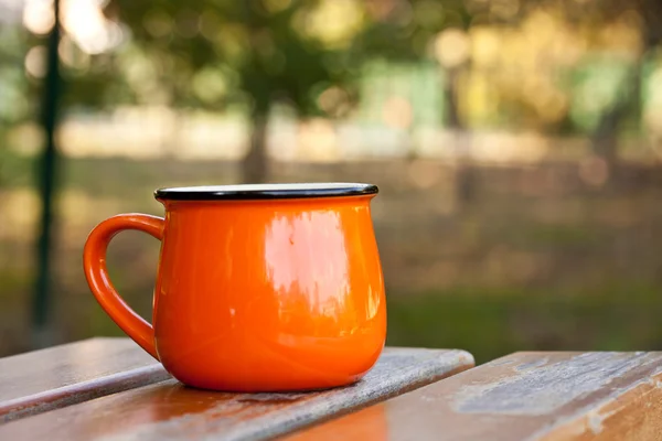 Orange enamel cup — Stock Photo, Image