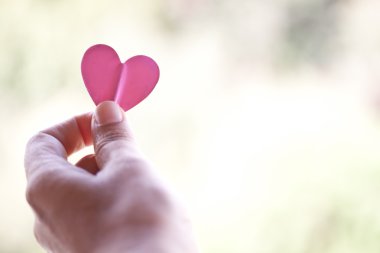 Hand holding paper heart clipart