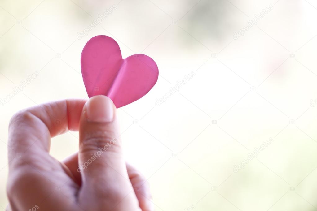 Hand holding paper heart