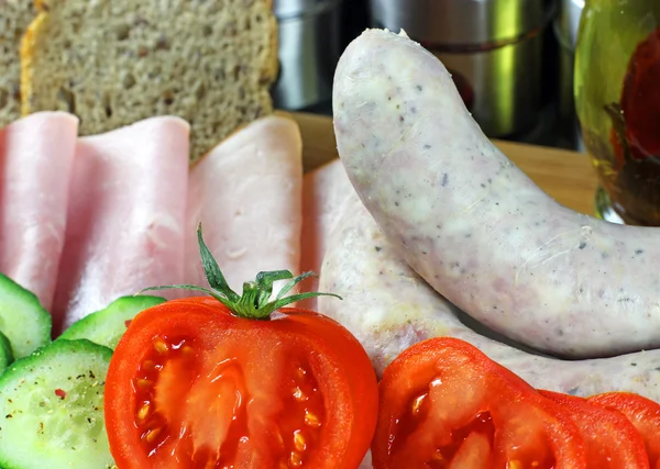 Tomatoes, cucumber, ham and white sausage — Stock Photo, Image