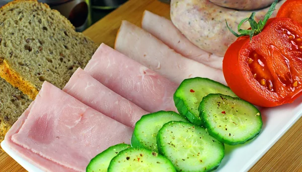 Tomatoes, cucumber, ham and white sausage — Stock Photo, Image