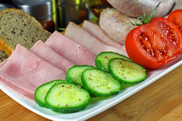 Tomatoes, cucumber, ham and white sausage — Stock Photo, Image