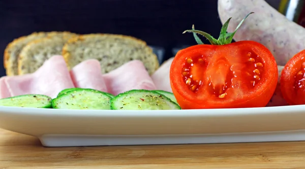 Tomatoes, cucumber, ham and white sausage — Stock Photo, Image