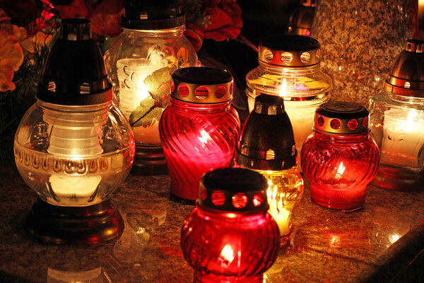 Candles Burning At a Cemetery During All Saints Day .